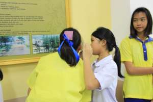 Younger and older student working together