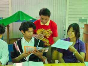 Teacher helping students