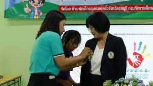 The director receiving a flower from a student