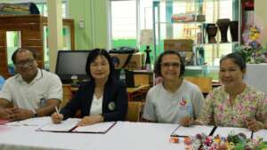 Signing the MOU with the director of education.