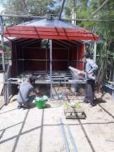 Workers building chicken pen.