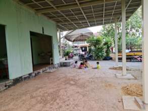 The area that needs cement to make a 2nd classroom