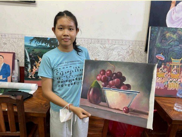 Ms. Sh age 14 holding her painting