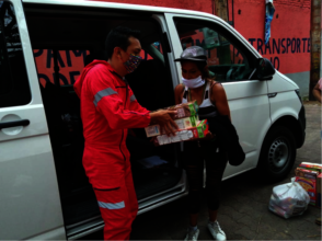 Giving groceries to families.