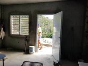 Doors are added to a rebuilt house on St John