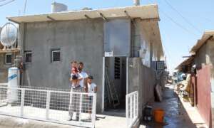 Syrian refugee family and newly upgraded shelter