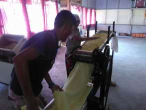 The machine is operated by two employees.