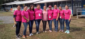 A group of women posing in front of govt. shelter.
