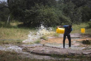 Our staff clearing the water hole for our animals