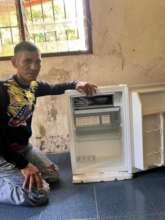 Yabarana electrician displays the antivenom fridge