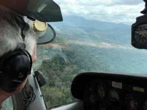 Bush pilot Enrique approaches Kayama with supplies