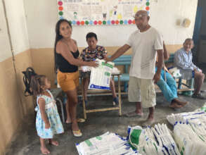 Community members recording the delivery of nets