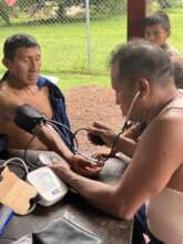 Majagua nurse checks a community leader's health