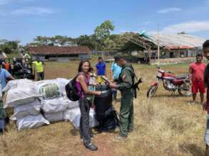 Checking mosquito nets on receipt in Manipiare