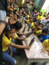 Children making eco-bricks