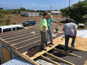 Members of the LTRG providing roofing to a family