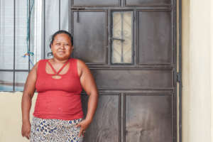 Angela in front of her new Habitat home