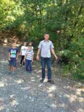 Mithat Suma with his children near the minefield.