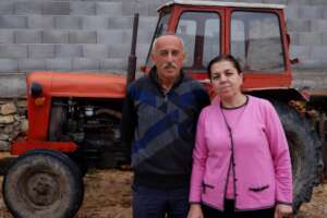 Arif and Nezire in their yard