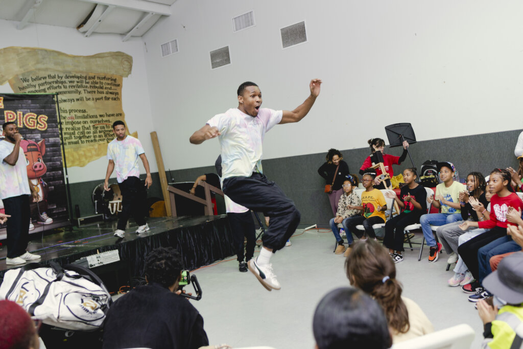 Children enjoying breakdancing performance