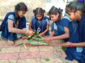 Children making boats out of natural materials