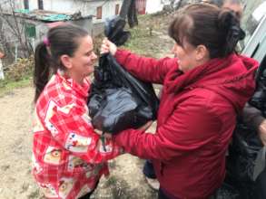 NG coworker Anila delivering an aid package
