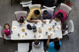 Migrant families are fed at a shelter in Tijuana