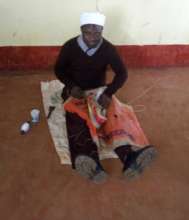 Issac practicing his shoe mending skills