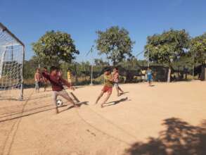 Kids playing soccer at the Helping Hands school