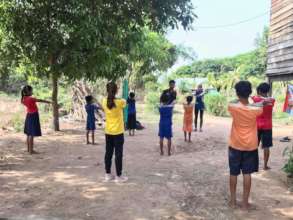 Stretching during a socially-distanced lesson!