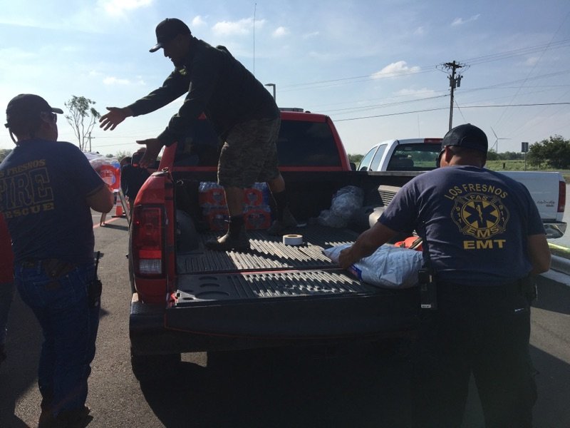 Local officials help with water distribution.