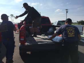 Local officials help with water distribution.
