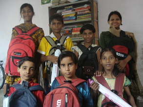 A few kids with the education materials