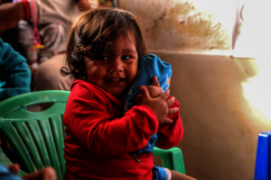 Aranza plays in a UNICEF Child Friendly Space