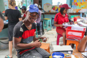 After-school Facilitator Mbusi preparing for class