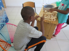 A student and his sister play with blocks