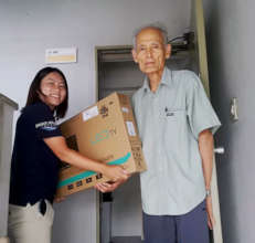A man receives a television for his temporary home