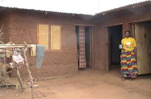 Roseline in front of her house.