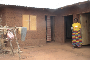 Roseline in front of her house.