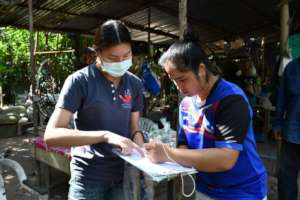 Signing for food parcels, ensuring accountability.