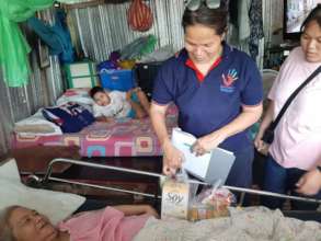 A paralysed lady receiving food