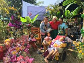 A severely disabled boy and family recieve food.