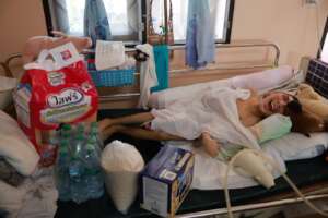 A disabled boy receiving pampers and milk.