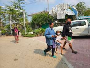 Families arrive to receive food.