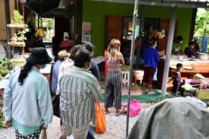 Lines of people waiting for their food.