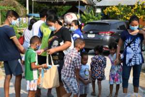 Happy Families receiving gifts of food.