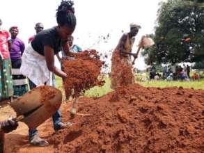 Parents dig the new latrine at Awach (August 2018)