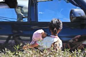 Street Kids with her baby sibling begging