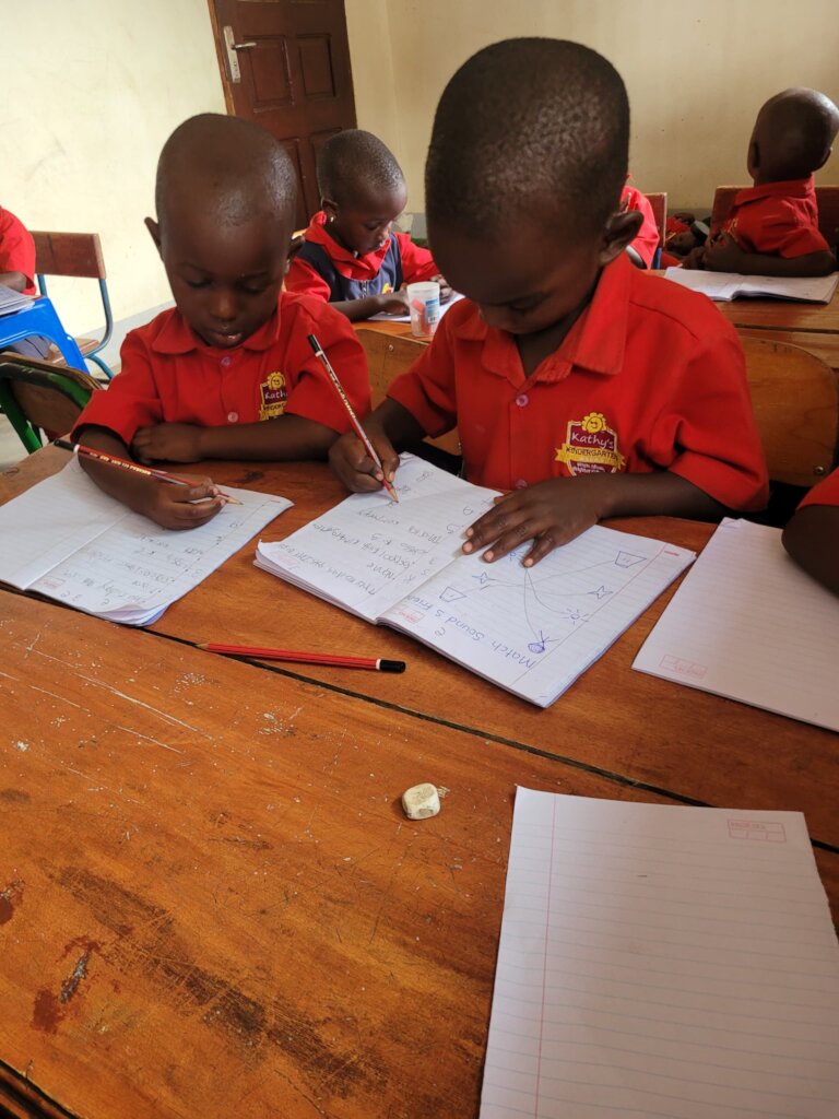 Jovan and freind learn to use a pencil
