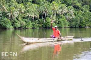 Indonesia - Man in Canoe